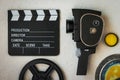 A movie camera, a clapperboard, a film box and a yellow filter Royalty Free Stock Photo