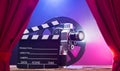 Movie Camera With Clapperboard And Film Reel On Stage Royalty Free Stock Photo