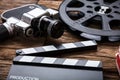 Movie Camera With Film Reel And Clapper Board On Wood Royalty Free Stock Photo