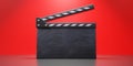 Movie clapper, blank empty clapperboard on red background, copy space. Filmmaking, video. 3d render