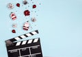 Movie clapper board with Christmas decorations on a blue background with copy space Royalty Free Stock Photo