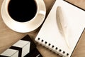 Movie clapper, cup of coffee and fountain pen diary top view Royalty Free Stock Photo