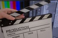 Movie clapper and editing room in background Royalty Free Stock Photo