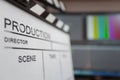 Movie clapper and editing room in background Royalty Free Stock Photo