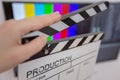 Movie clapper and editing room in background Royalty Free Stock Photo