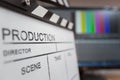 Movie clapper and editing room in background Royalty Free Stock Photo