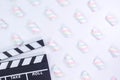 Movie clapperboard White background. White background with twisted marshmallow pattern. Mock up. Space for text