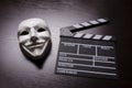 Movie clapperboard and white mask Royalty Free Stock Photo