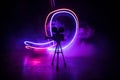 Movie concept. Miniature movie set on dark toned background with fog and empty space. Silhouette of vintage camera on tripod Royalty Free Stock Photo