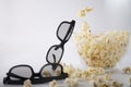 Movie items, 3D glasses and popcorn in a cup. Royalty Free Stock Photo