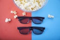 Movie items, 3D glasses and popcorn in a cup. Royalty Free Stock Photo