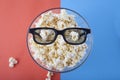 Movie items, 3D glasses and popcorn in a cup.. Royalty Free Stock Photo