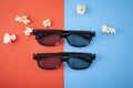 Movie items, 3D glasses and popcorn in a cup. Royalty Free Stock Photo