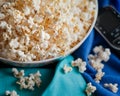 Movie night with remote, popcorn bowl and blanket. Royalty Free Stock Photo