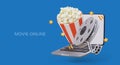 Movie online. Realistic open laptop, bucket full of popcorn, cinematic tape on reel Royalty Free Stock Photo