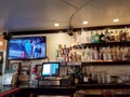 Movie plays on TV inside Local Downbeat Diner Bar Royalty Free Stock Photo