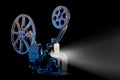 Movie projector with film reels on black background Royalty Free Stock Photo