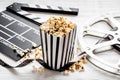 Movie reel with popcorn and clapperboard. Cinema background Royalty Free Stock Photo