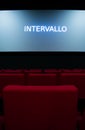 Movie screen and red chairs inside of a cinema Royalty Free Stock Photo