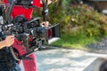 Movie shooting or video production and film crew team with camera equipment. Video camera operator working with equipment. Directo Royalty Free Stock Photo