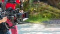 Movie shooting or video production and film crew team with camera equipment. Video camera operator working with equipment. Directo Royalty Free Stock Photo