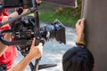 Movie shooting or video production and film crew team with camera equipment. Video camera operator working with equipment. Directo