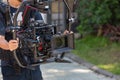 Movie shooting or video production and film crew team with camera equipment. Video camera operator working with equipment. Directo Royalty Free Stock Photo