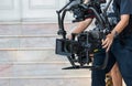 Movie shooting or video production and film crew team with camera equipment. Video camera operator working with equipment. Directo