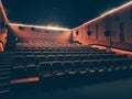 Movie theater with many red seats or chairs in dark empty auditorium Royalty Free Stock Photo