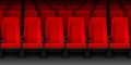 Movie theater with rows of red empty chairs