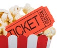 Movie ticket close up in a box of popcorn isolated on white Royalty Free Stock Photo