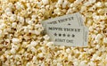 Movie tickets on popcorn snack background. Home theatre movie or series night concept. Flat lay top view from above