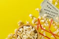 Movie tickets, soda drink plastic straws and popcorn on yellow table background. Home theatre movie or series night concept. Flat