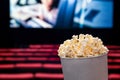 Movies and popcorn. Pop corn at cinema. Family film night concept. Action or romantic comedy entertainment on screen.
