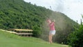 Moving blurry too soft. Asia Golfer woman hitting golf ball out of a sand trap Royalty Free Stock Photo