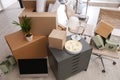 Moving boxes and furniture in office Royalty Free Stock Photo