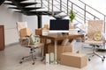 Moving boxes and furniture in office Royalty Free Stock Photo