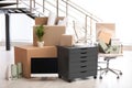 Moving boxes and furniture in office Royalty Free Stock Photo