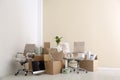 Moving boxes and furniture in new office Royalty Free Stock Photo