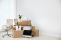 Moving boxes and furniture in new office Royalty Free Stock Photo