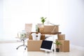 Moving boxes and furniture in new office. Royalty Free Stock Photo