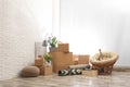 Moving boxes and stuff near brick wall in room Royalty Free Stock Photo