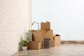 Moving boxes and stuff near white brick wall in room Royalty Free Stock Photo