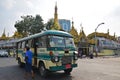 A moving bus and a pedestrian in front of Sule Pagoda in downtown Yangon, Myanmar Royalty Free Stock Photo