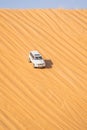 A moving car through sand dunes in desert during LIWA motor fest, moreeb dunes Royalty Free Stock Photo