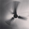 A moving ceiling fan shot with slower shutter speed.