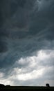 Dramatic dark cloudy sky over the city, roofs of buildings Royalty Free Stock Photo