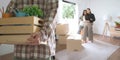 Moving day. close up male asian hand carrying box for move from old to new home or residence with two female friends in Royalty Free Stock Photo