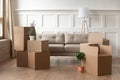 Moving day concept, cardboard boxes in modern house living room Royalty Free Stock Photo