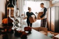 Moving day, new home, unpacking boxes. Happy couple in their new apartment is having fun with cardboard boxes. Cheerful Royalty Free Stock Photo